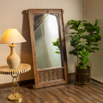 Rustic Full-Length Mirror with Carved Wooden Frame and Arched Design.