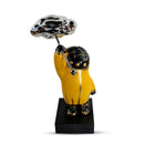 luxury sculpture features a yellow figure carrying a cloud